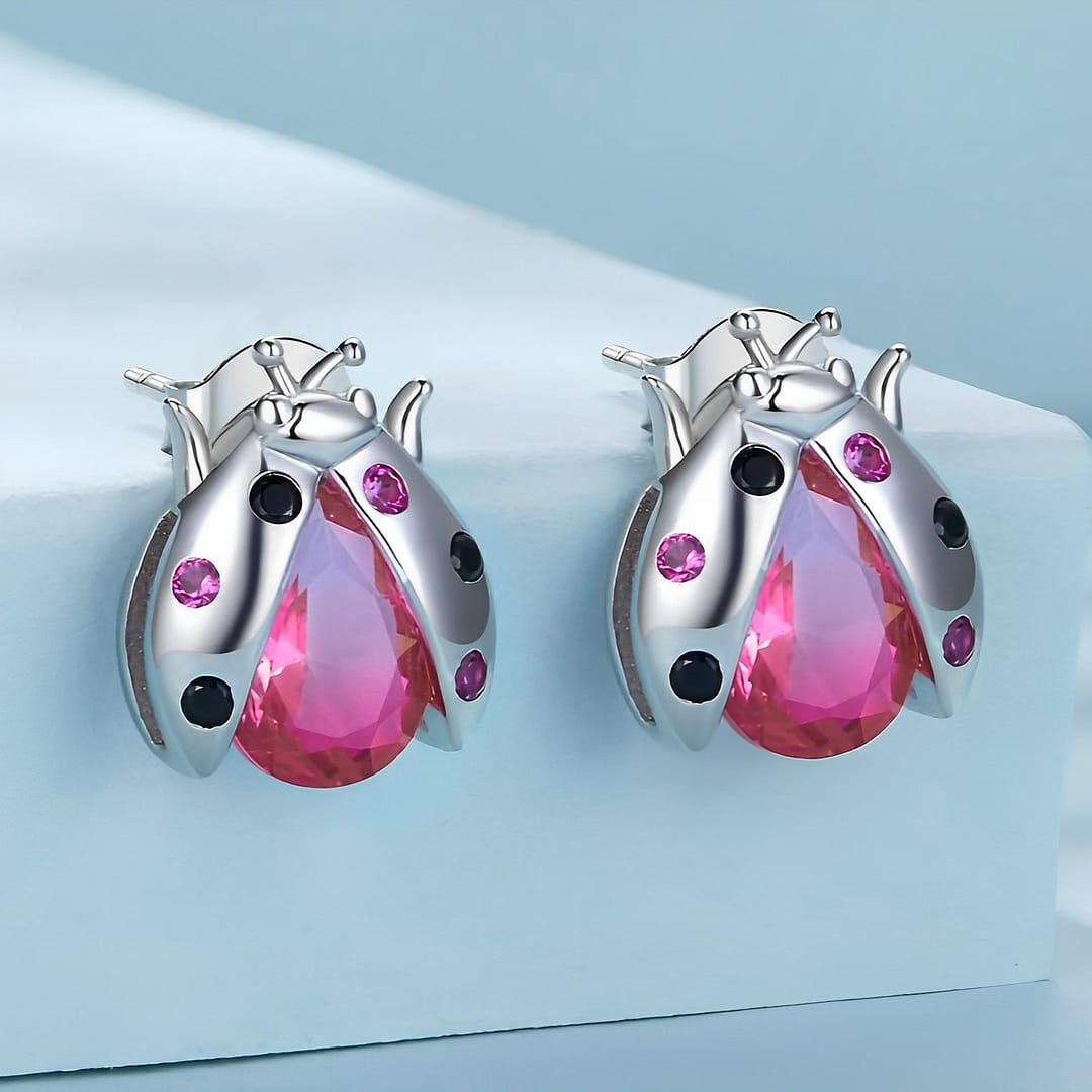 Exquisite Ladybug Stud Earrings | S925 Sterling Silver | Go Glam Girl 3 Exquisite Ladybug Stud Earrings: Sterling silver earrings with pink glass body, cubic zirconia-studded wings. Symbolic and whimsical jewelry for women. Perfect for adding charm and luck to your style.