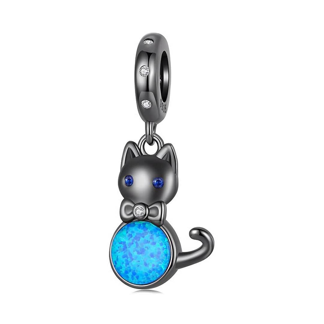 Elegant Black Cat Dangle Charm in s925 sterling silver, plated in black gold, featuring blue opal, cubic zirconia eyes, and a bow accent. Hypoallergenic and perfect for charm bracelets & necklaces. A must-have for cat lovers!