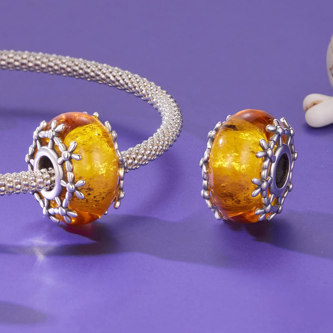 Home 22 Orange Floral Glass Charm featuring glowing marigold-inspired glass bead with sterling silver floral detailing around the edges.