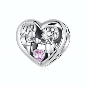 Sterling silver heart charm with boy and girl holding a pink cubic zirconia stone heart, part of Innocent Love Charms Collection.