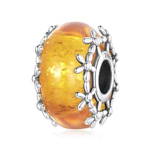 Orange Floral Glass Charm featuring glowing marigold-inspired glass bead with sterling silver floral detailing around the edges.