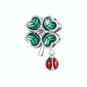 Lucky charm jewelry: Ladybug & Four Leaf Clover Charm in s925 sterling silver with green enamel leaves and sparkling cubic zirconia. Symbol of fortune and style.