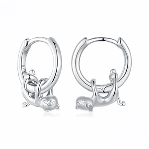 Sterling silver hoop earrings with cute cat charms, perfect for cat lovers. Adorable accessory for any outfit.