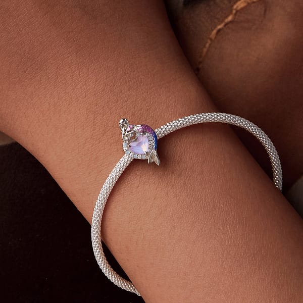 Dive into Style: 10 Must-Have Ocean-Inspired Jewelry Pieces of 2023 41 Sterling silver heart charm with pink glass center, opal, and cubic zirconia stones. Features a mermaid with pink and purple tail on one side. Back engraved with mermaid tail.