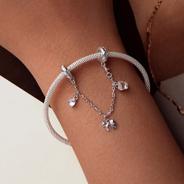 Buzzworthy Beauties: 10 Must-Have Bug-Inspired Jewelry Pieces of 2023 36 Sterling silver Ballet Safety Chain featuring pink butterfly, silver ribbon bow, and blue moonstone heart charms.