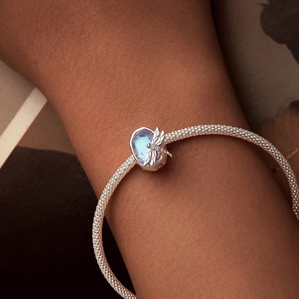 Buzzworthy Beauties: 10 Must-Have Bug-Inspired Jewelry Pieces of 2023 36 Sterling silver Dragonflies Dream Charm from Monet's Garden Collection, adorned with opal stones, captures the beauty of nature.