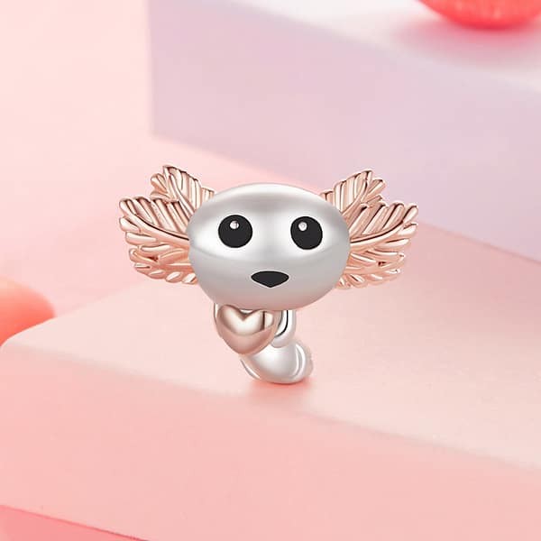 Celebrate Your Love for Pets on National Love Your Pet Day 32 Cute Axolotl Charm in s925 sterling silver with rose-gold-plated gills, holding a tiny heart, part of the Pet Charms Collection. Unique, animal-inspired jewelry with enamel and white gold plating. Perfect charm for animal lovers or as a thoughtful gift.