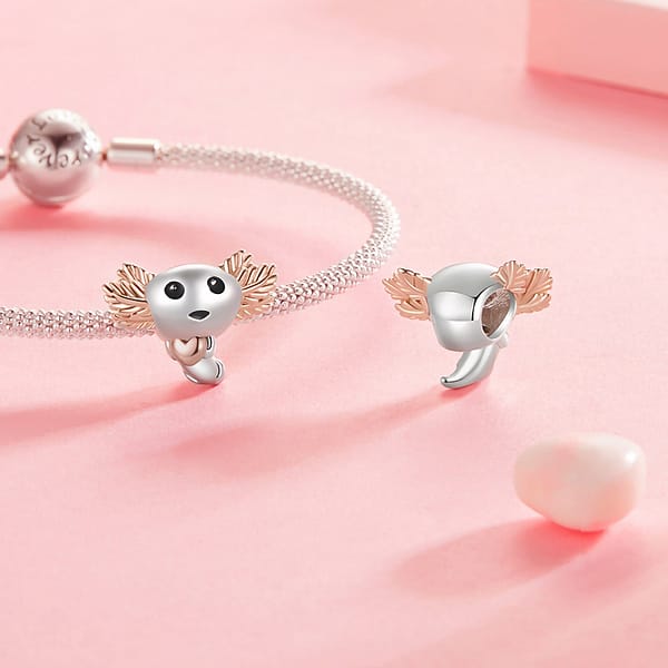 Celebrate Your Love for Pets on National Love Your Pet Day 30 Cute Axolotl Charm in s925 sterling silver with rose-gold-plated gills, holding a tiny heart, part of the Pet Charms Collection. Unique, animal-inspired jewelry with enamel and white gold plating. Perfect charm for animal lovers or as a thoughtful gift.