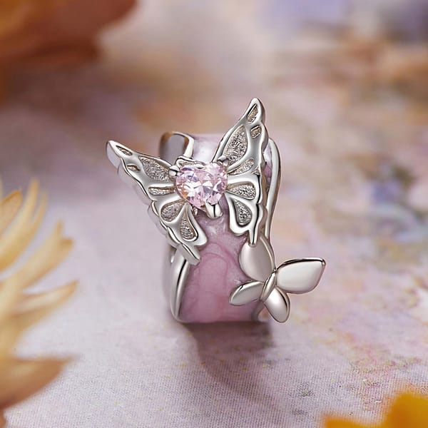 Buzzworthy Beauties: 10 Must-Have Bug-Inspired Jewelry Pieces of 2023 13 Monet's Garden Butterflies Dream Spacer Charm: Sterling silver spacer charm with pink enamel, featuring two silver butterflies and pink glass crystal.