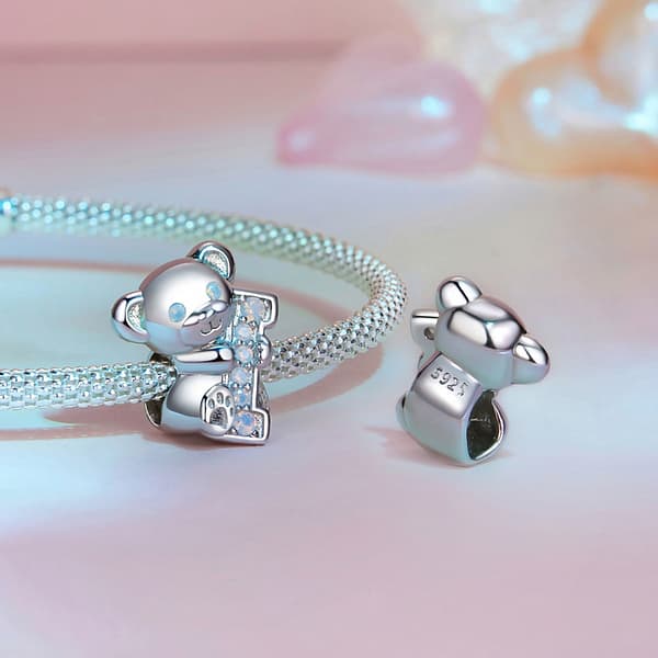 From Teddy Bears to Heartfelt Tokens: The Evolution of Love on Valentine's Day 27 Sterling silver Teddy Bear Love Charm, a romantic accessory for Valentine's Day. Opal-studded bear hugs the letter 'I'. Create 'I Love U' with our charming collection. Perfect gift for a loved one. #TeddyBearCharm #ValentinesJewelry #LoveGift