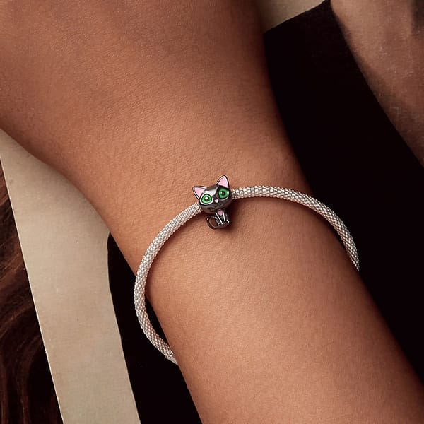 Celebrate Your Love for Pets on National Love Your Pet Day 23 Cute Black Cat Charm made of s925 sterling silver, plated in black gold, with green enamel eyes and pink heart details. Part of the Pet Charms Collection, perfect for cat lovers and charm collectors.