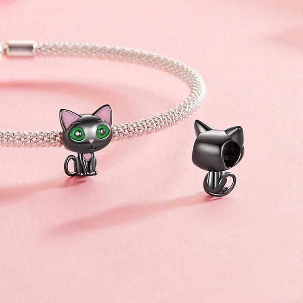 Celebrate Your Love for Pets on National Love Your Pet Day 20 Cute Black Cat Charm made of s925 sterling silver, plated in black gold, with green enamel eyes and pink heart details. Part of the Pet Charms Collection, perfect for cat lovers and charm collectors.