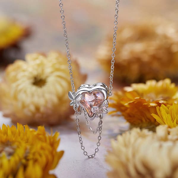 Buzzworthy Beauties: 10 Must-Have Bug-Inspired Jewelry Pieces of 2023 30 Sterling silver charm featuring opal-studded butterflies on heart-shaped pink glass, part of Monet's Garden Charms Collection