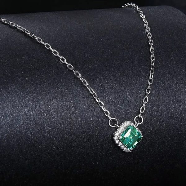 Affordable Glam: Moissanite Jewelry That Looks Expensive But Won't Break the Bank 35 Elegant s925 sterling silver necklace with a 0.6 carat emerald green moissanite surrounded by sparkling cubic zirconia stones. Timeless sophistication for any occasion. #EmeraldMoissanite #FineJewelry