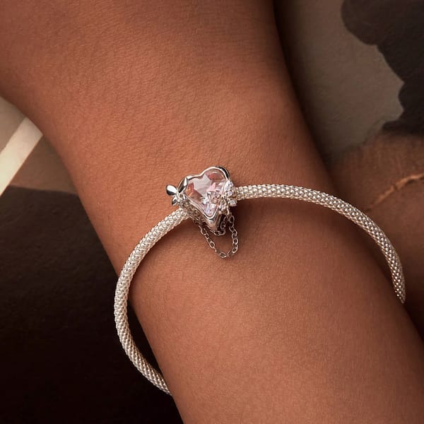 Buzzworthy Beauties: 10 Must-Have Bug-Inspired Jewelry Pieces of 2023 31 Sterling silver charm featuring opal-studded butterflies on heart-shaped pink glass, part of Monet's Garden Charms Collection