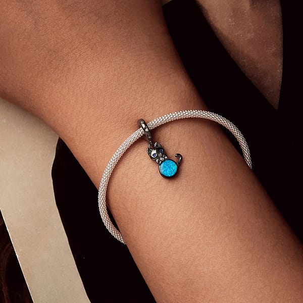 Celebrate Your Love for Pets on National Love Your Pet Day 13 Elegant Black Cat Dangle Charm in s925 sterling silver, plated in black gold, featuring blue opal, cubic zirconia eyes, and a bow accent. Hypoallergenic and perfect for charm bracelets & necklaces. A must-have for cat lovers!
