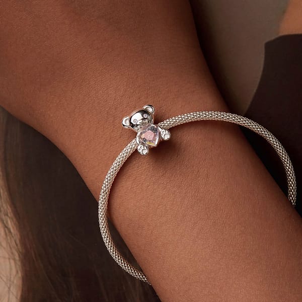 From Teddy Bears to Heartfelt Tokens: The Evolution of Love on Valentine's Day 25 Sterling silver Pink Heart Teddy Bear Love Charm, a whimsical addition to our Teddy Bears Love Charms Collection. Adorned with opal eyes, perfect for Valentine's Day. Combine with other charms to create 'I Love U.' #LoveCharm #ValentinesJewelry #TeddyBearCharm
