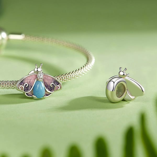 Buzzworthy Beauties: 10 Must-Have Bug-Inspired Jewelry Pieces of 2023 40 S925 sterling silver Luminous Purple Moth Stopper Charm. Rich purple hues, sparkling cubic zirconia, and a glowing lower body. Perfect for spring. From the Luminous Night Charms Collection.