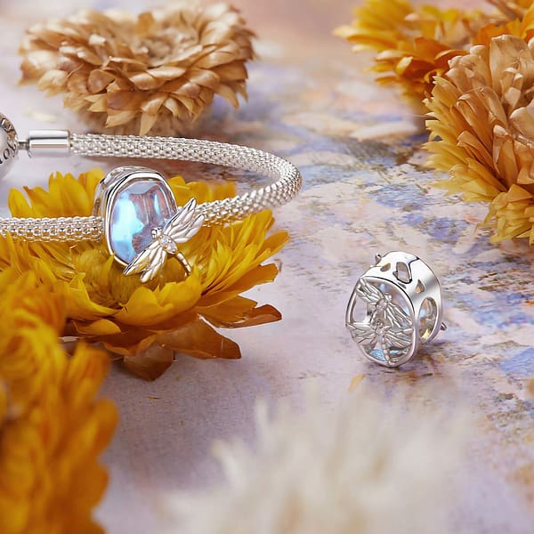 Buzzworthy Beauties: 10 Must-Have Bug-Inspired Jewelry Pieces of 2023 33 Sterling silver Dragonflies Dream Charm from Monet's Garden Collection, adorned with opal stones, captures the beauty of nature.