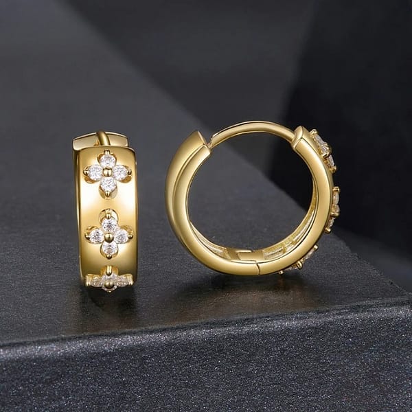 Affordable Glam: Moissanite Jewelry That Looks Expensive But Won't Break the Bank 22 These Golden Four Leaf Clovers Moissanite Hoop Earrings feature shimmering D-color moissanite stones arranged in delicate clover motifs. A timeless design that brings sparkle to every moment.