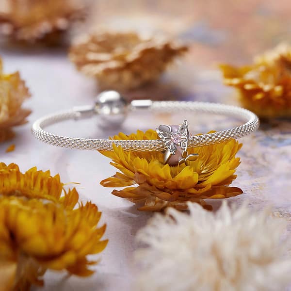 Buzzworthy Beauties: 10 Must-Have Bug-Inspired Jewelry Pieces of 2023 15 Monet's Garden Butterflies Dream Spacer Charm: Sterling silver spacer charm with pink enamel, featuring two silver butterflies and pink glass crystal.