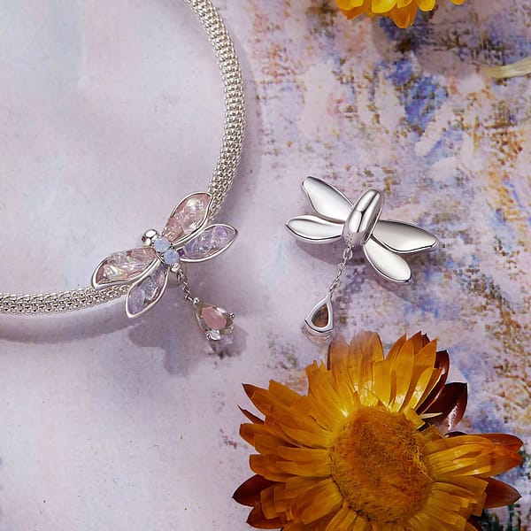 Buzzworthy Beauties: 10 Must-Have Bug-Inspired Jewelry Pieces of 2023 18 Monet's Garden Dragonfly Stopper Charm in sterling silver, adorned with pink and purple glass stones. Perfect for bracelet. Nature-inspired jewelry.