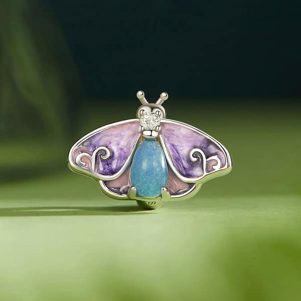 Buzzworthy Beauties: 10 Must-Have Bug-Inspired Jewelry Pieces of 2023 38 S925 sterling silver Luminous Purple Moth Stopper Charm. Rich purple hues, sparkling cubic zirconia, and a glowing lower body. Perfect for spring. From the Luminous Night Charms Collection.